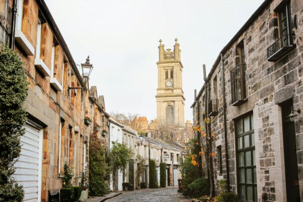 Illustrative stone-lined street with a clock tower